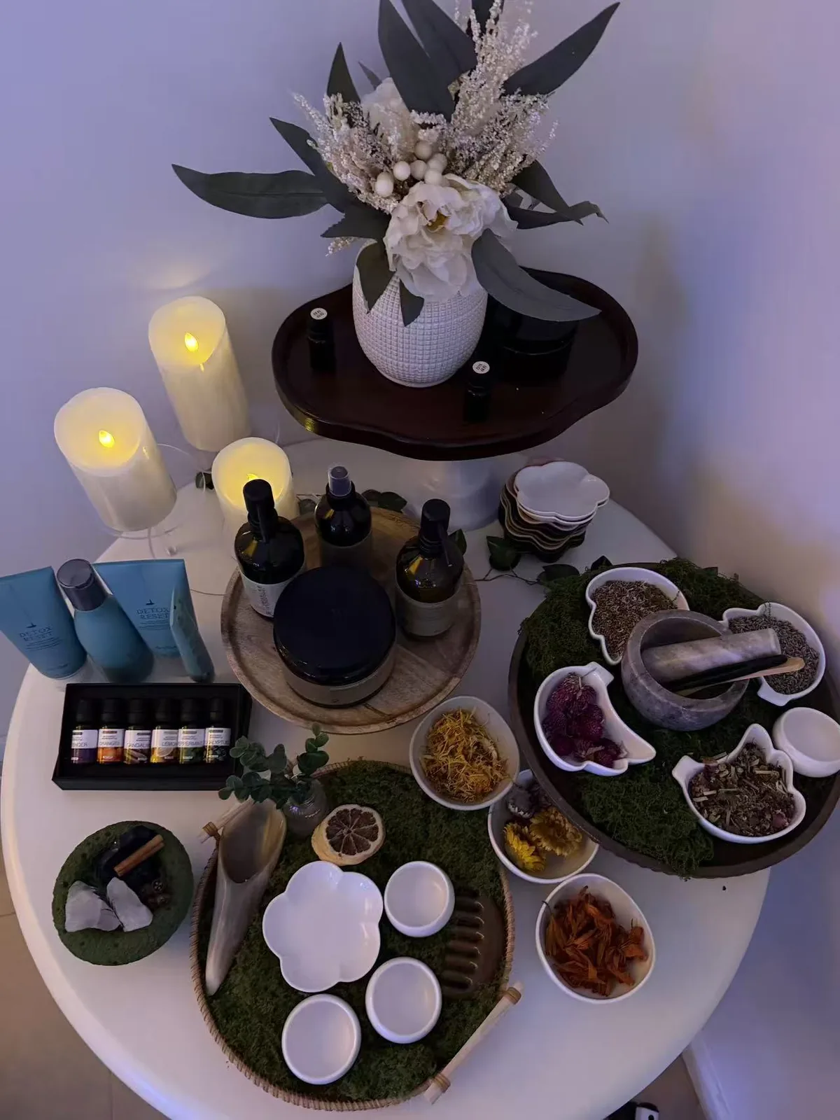Botanical scalp-care flat lay with herbs and oils at Jinyue Head Spa