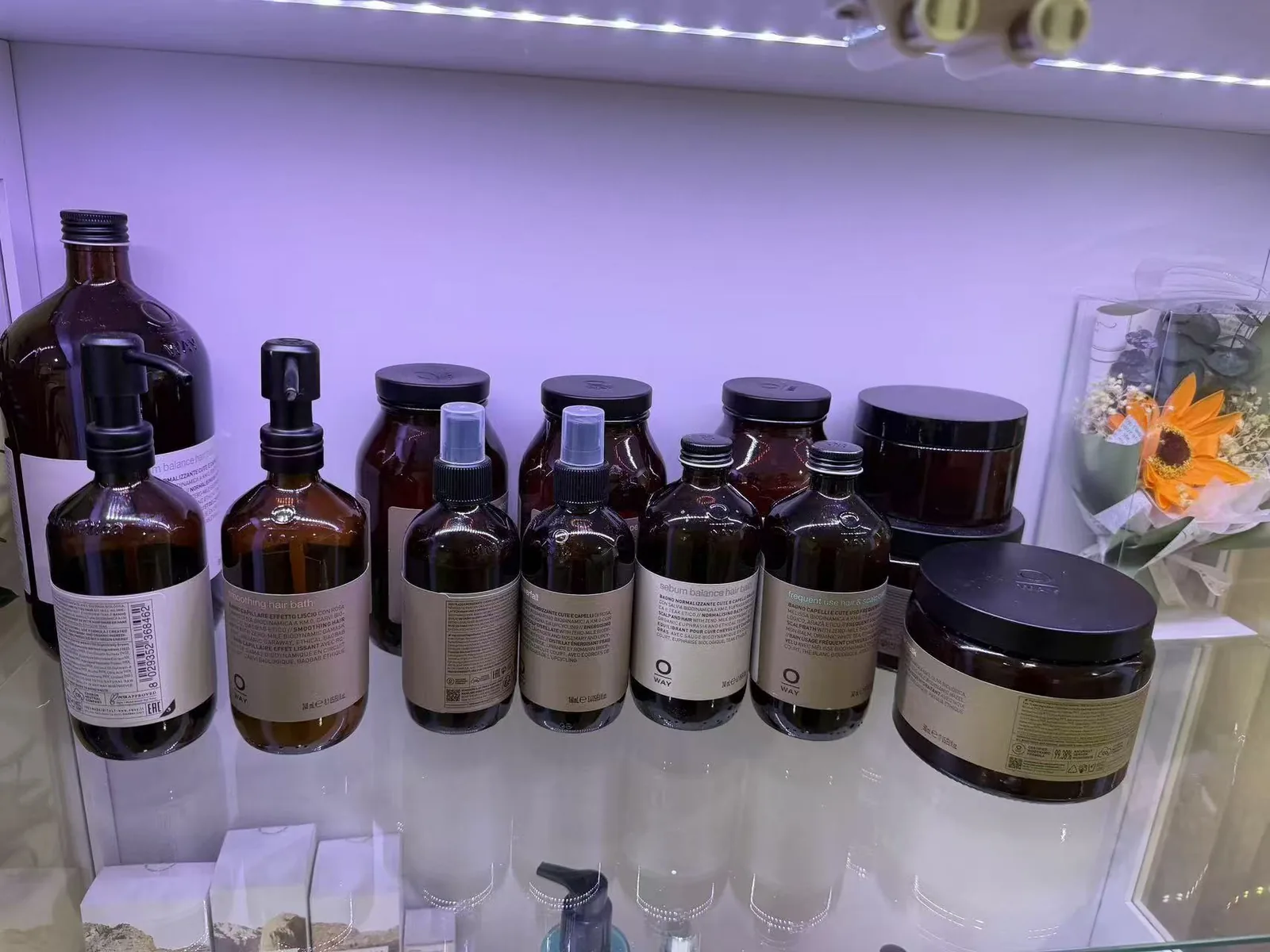 Oway professional botanical hair and scalp care products on a shelf at Jinyue Head Spa